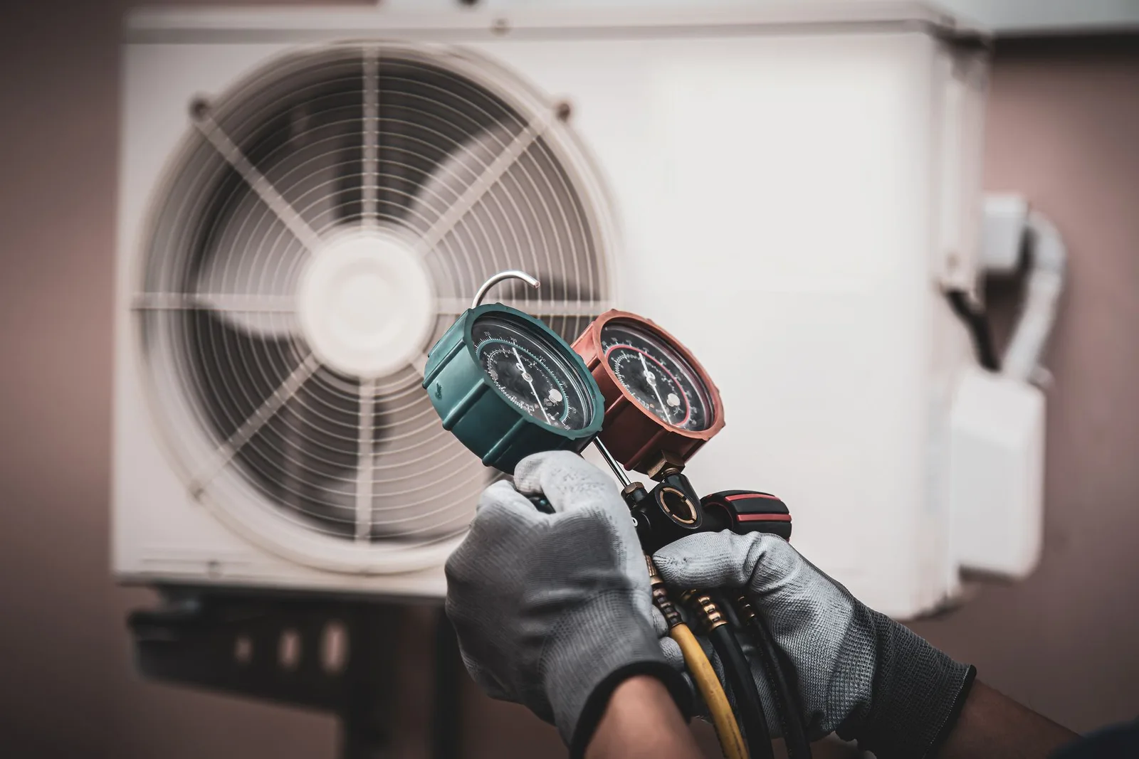 A.R.C.C. Mechanical technician checking a gauge on an air conditioning system